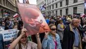 Protesters hold a placard depicting an unborn baby as they take part in the March of Life in Warsaw, on April 14, 2024.