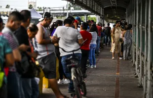 Migrants mostly form Central America wait in line to cross the border at the Gateway International Bridge into the U.S. from Matamoros, Mexico, to Brownsville, Texas, on June 4, 2024. Credit: CHANDAN KHANNA/AFP via Getty Images