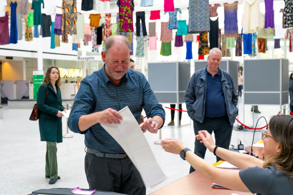 A man receives his ballot for the European elections in a polling station in The Hague on June 6, 2024, on the first day of the European Parliament election.?w=200&h=150