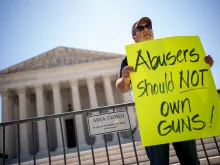 Christian Defense Coalition Director Rev. Patrick Mahoney holds a sign that reads "Abusers Should NOT Own Guns!" outside the Supreme Court on June 21, 2024, in Washington, D.C.
