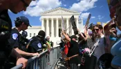 U.S. Supreme Court police officers put up barricades to separate pro-life activists (right) from abortion rights activists during a demonstration in front of the Supreme Court in Washington, D.C., on June 24, 2024.