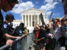 U.S. Supreme Court police officers put up barricades to separate pro-life activists (right) from abortion rights activists during a demonstration in front of the Supreme Court in Washington, D.C., on June 24, 2024.