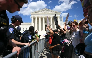 U.S. Supreme Court police officers put up barricades to separate pro-life activists (right) from abortion rights activists during a demonstration in front of the Supreme Court in Washington, D.C., on June 24, 2024. Credit: JIM WATSON/AFP via Getty Images