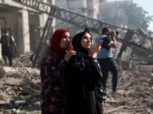 Palestinian women react as they look at the badly damaged Latin Patriarchate Holy Family School after it was reportedly hit during Israeli military bombardment in Gaza City on July 7, 2024, amid the ongoing conflict in the Palestinian territory between Israel and Hamas.