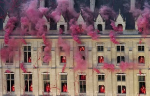 Smoke billows near windows as performers participate in the opening ceremony of the 2024 Olympic Games in Paris on July 26, 2024. Credit: BERNAT ARMANGUE/POOL/AFP/Getty Images