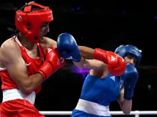 Algeria's Imane Khelif (in red) punches Italy’s Angela Carini in the women’s 66kg preliminaries round of 16 boxing match during the Paris 2024 Olympic Games at the North Paris Arena in Villepinte on Aug. 1, 2024.