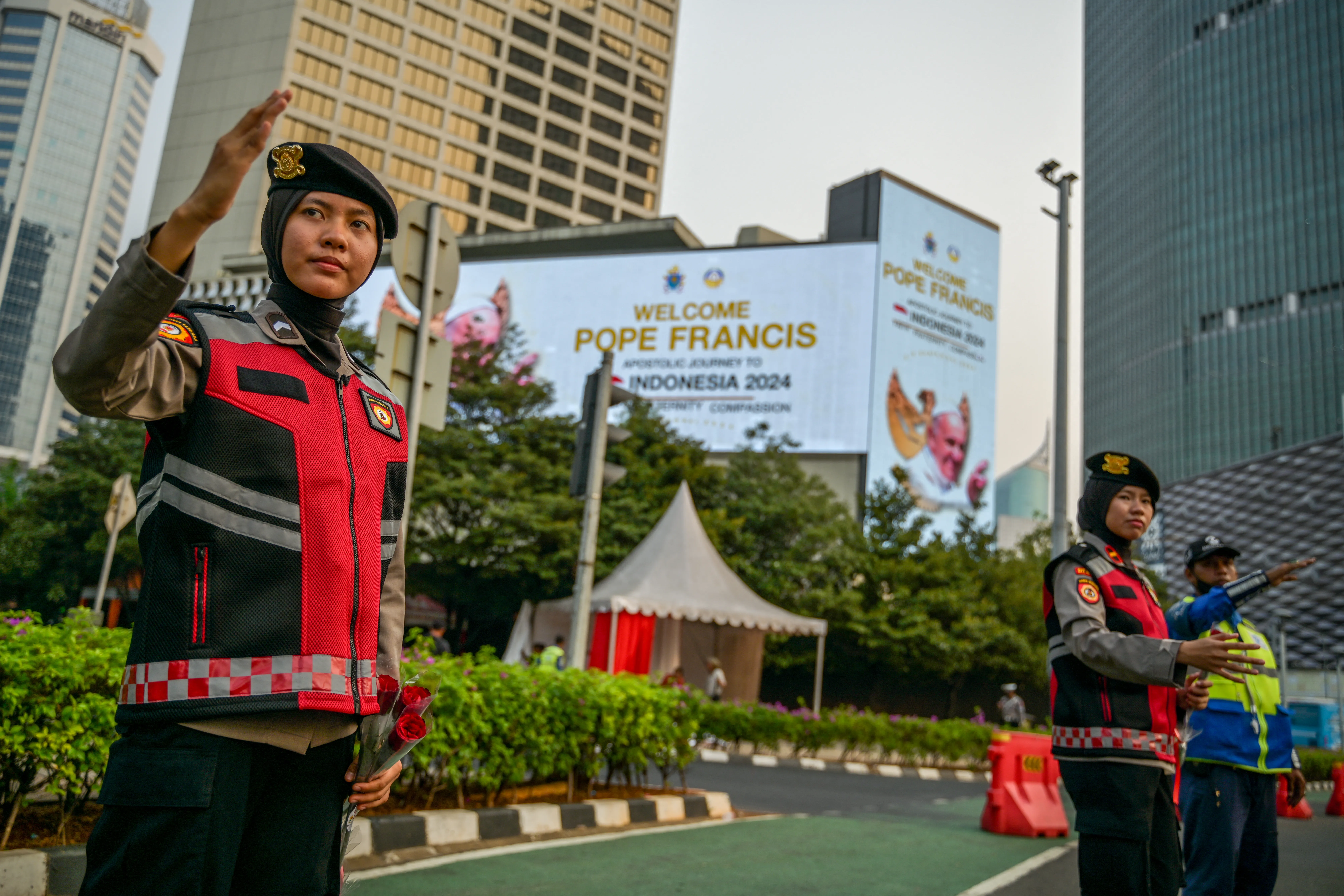 Indonesian police direct traffic next to billboards displaying a welcome message for Pope Francis in Jakarta on Sept. 2, 2024.?w=200&h=150