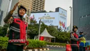 Indonesian police direct traffic next to billboards displaying a welcome message for Pope Francis in Jakarta on Sept. 2, 2024.