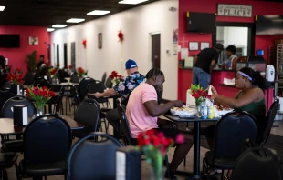 Haitians sit down to eat their meal at a Haitian restaurant in Springfield, Ohio, on Sept. 12, 2024. Credit: ROBERTO SCHMIDT/AFP via Getty Images