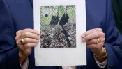 Palm Beach County Sheriff Ric Bradshaw holds a photograph of the rifle and other items found near where a suspect was discovered during a press conference regarding an apparent assassination attempt of former President Donald Trump on Sept. 15, 2024, in West Palm Beach, Florida.