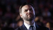 Republican vice presidential candidate Sen. JD Vance listens as Republican presidential nominee former president Donald Trump speaks at a campaign rally at the Butler Farm Show fairgrounds on Oct. 5, 2024, in Butler, Pennsylvania.