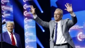 Republican presidential nominee and former president Donald Trump welcomes Robert F. Kennedy Jr. to the stage at a Turning Point Action campaign rally at the Gas South Arena on Oct. 23, 2024, in Duluth, Georgia.