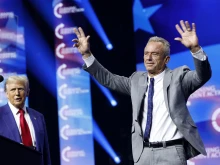 Republican presidential nominee and former president Donald Trump welcomes Robert F. Kennedy Jr. to the stage at a Turning Point Action campaign rally at the Gas South Arena on Oct. 23, 2024, in Duluth, Georgia.