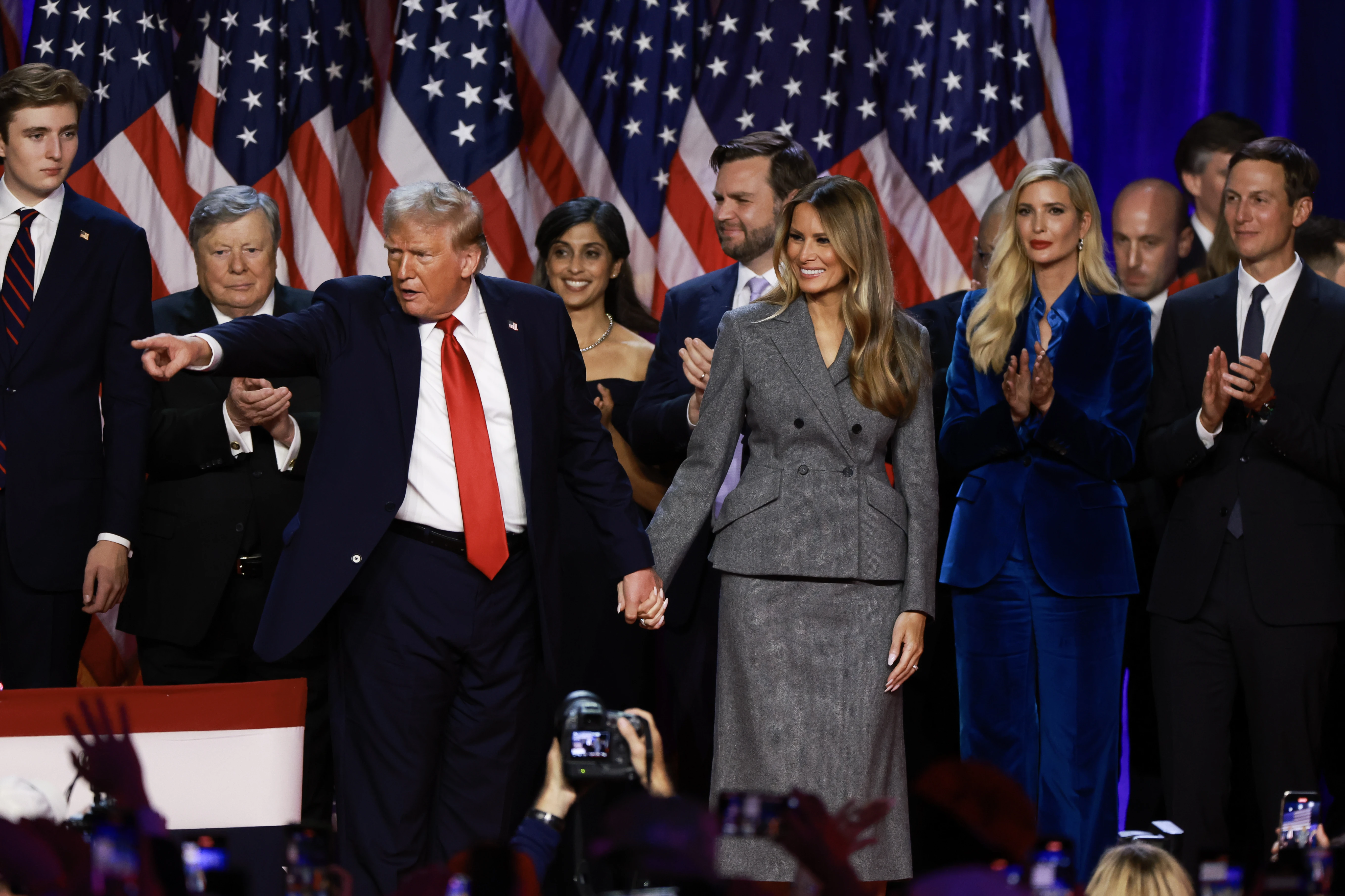 Republican presidential nominee former president Donald Trump points to supporters with former first lady Melania Trump during an election night event at the Palm Beach Convention Center on Nov. 6, 2024, in West Palm Beach, Florida.?w=200&h=150