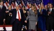 Republican presidential nominee former president Donald Trump points to supporters with former first lady Melania Trump during an election night event at the Palm Beach Convention Center on Nov. 6, 2024, in West Palm Beach, Florida.