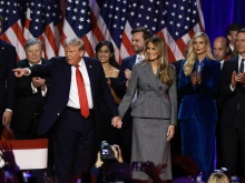 Republican presidential nominee former president Donald Trump points to supporters with former first lady Melania Trump during an election night event at the Palm Beach Convention Center on Nov. 6, 2024, in West Palm Beach, Florida.