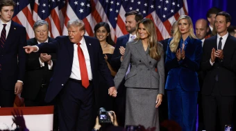 Republican presidential nominee former president Donald Trump points to supporters with former first lady Melania Trump during an election night event at the Palm Beach Convention Center on Nov. 6, 2024, in West Palm Beach, Florida.