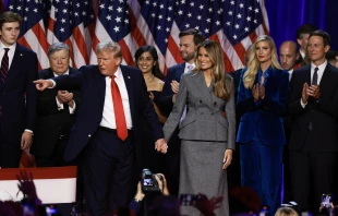 Republican presidential nominee former president Donald Trump points to supporters with former first lady Melania Trump during an election night event at the Palm Beach Convention Center on Nov. 6, 2024, in West Palm Beach, Florida. Credit: Joe Raedle/Getty Images