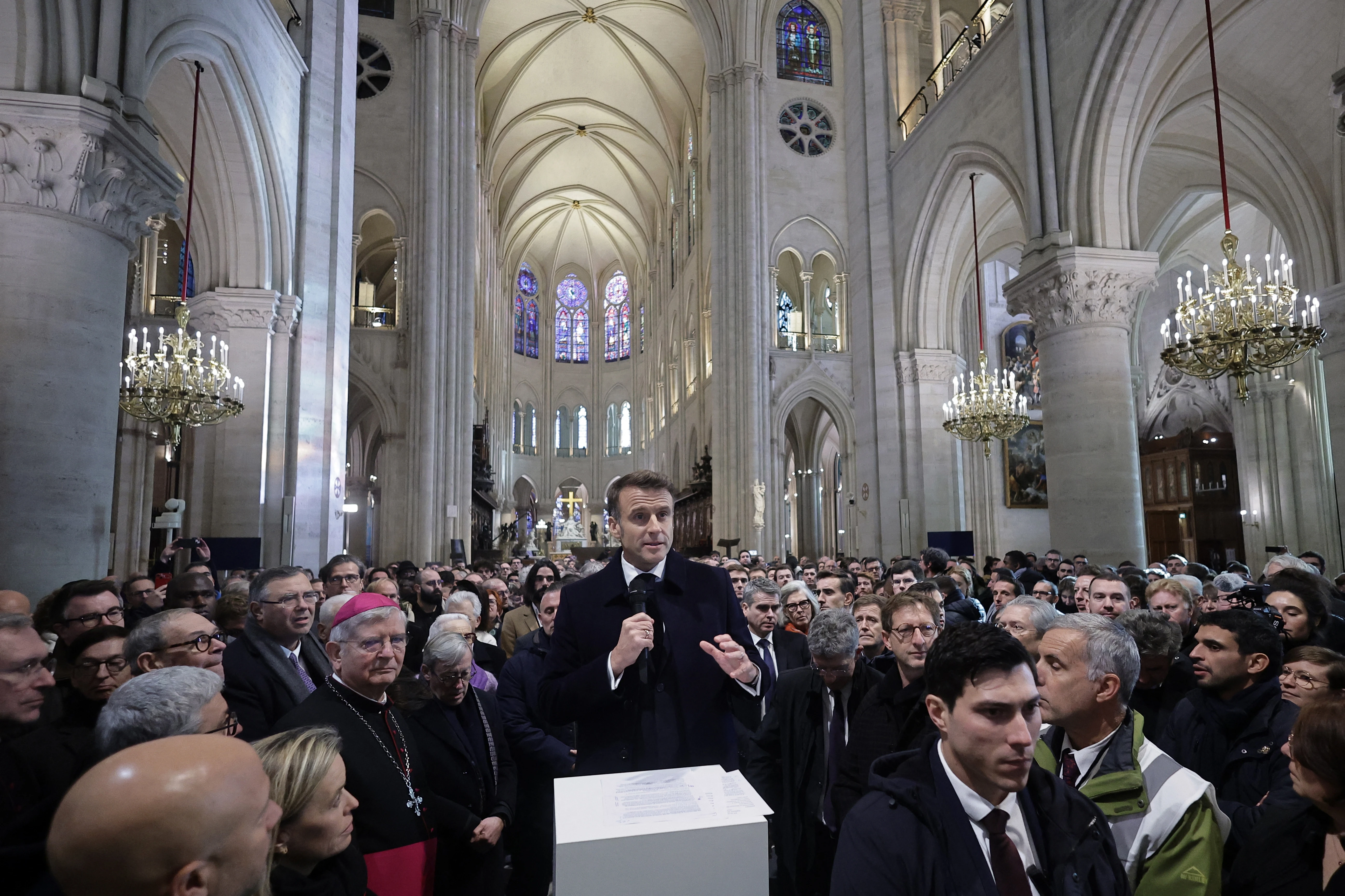 Attendees including workers of reconstruction of Notre-Dame de Paris Cathedral gather during a speech by French President Emmanuel Macron (center) in the nave of the cathedral in Paris on Nov. 29, 2024.?w=200&h=150