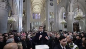 Attendees including workers of reconstruction of Notre-Dame de Paris Cathedral gather during a speech by French President Emmanuel Macron (center) in the nave of the cathedral in Paris on Nov. 29, 2024.