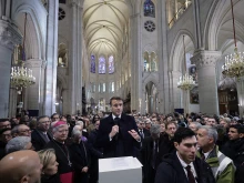 Attendees including workers of reconstruction of Notre-Dame de Paris Cathedral gather during a speech by French President Emmanuel Macron (center) in the nave of the cathedral in Paris on Nov. 29, 2024.