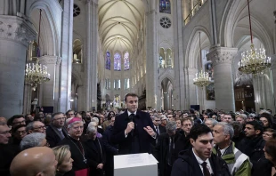 Attendees including workers of reconstruction of Notre-Dame de Paris Cathedral gather during a speech by French President Emmanuel Macron (center) in the nave of the cathedral in Paris on Nov. 29, 2024. Credit: CHRISTOPHE PETIT TESSON/POOL/AFP via Getty Images