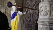 Archbishop of Paris, Laurent Ulrich, knocks on the door of Notre-Dame Cathedral during a ceremony to mark the re-opening of the landmark Cathedral, in central Paris, on Dec. 7, 2024.