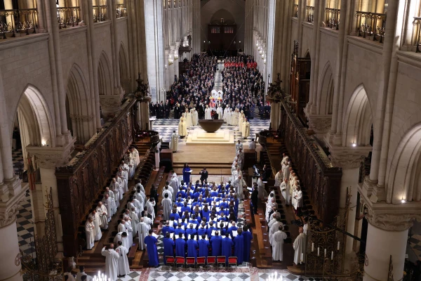 The choir, clergy and guests stand during the ceremony to mark the reopening of Notre-Dame of Paris Cathedral on Dec. 7, 2024, in Paris, France. After five years of restoration, Notre-Dame Cathedral in Paris reopened its doors to the world in the presence of Emmanuel Macron and around 50 heads of state, including President-elect Donald Trump, invited for the occasion. Credit: Pascal Le Segretain/Getty Images for Notre-Dame de Paris