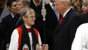 Episcopal Bishop Mariann Edgar Budde (left) arrives as U.S. President Donald Trump looks on during the National Prayer Service at Washington National Cathedral on Jan. 21, 2025, in Washington, DC..