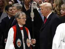 Episcopal Bishop Mariann Edgar Budde (left) arrives as U.S. President Donald Trump looks on during the National Prayer Service at Washington National Cathedral on Jan. 21, 2025, in Washington, DC..