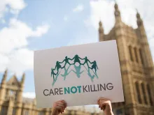 Campaigners against assisted dying gather outside the Houses of Parliament ahead of a House of Commons vote that rejected the legislation on Sept., 11, 2015, in London. Members of Parliament have voted 330 to 118 against a bill that would have allowed doctors to help some terminally ill people end their lives. Campaigners from both sides of the debate gathered outside Parliament, holding placards and voicing their opinions ahead of the first House of Commons vote on assisted dying for 20 years.