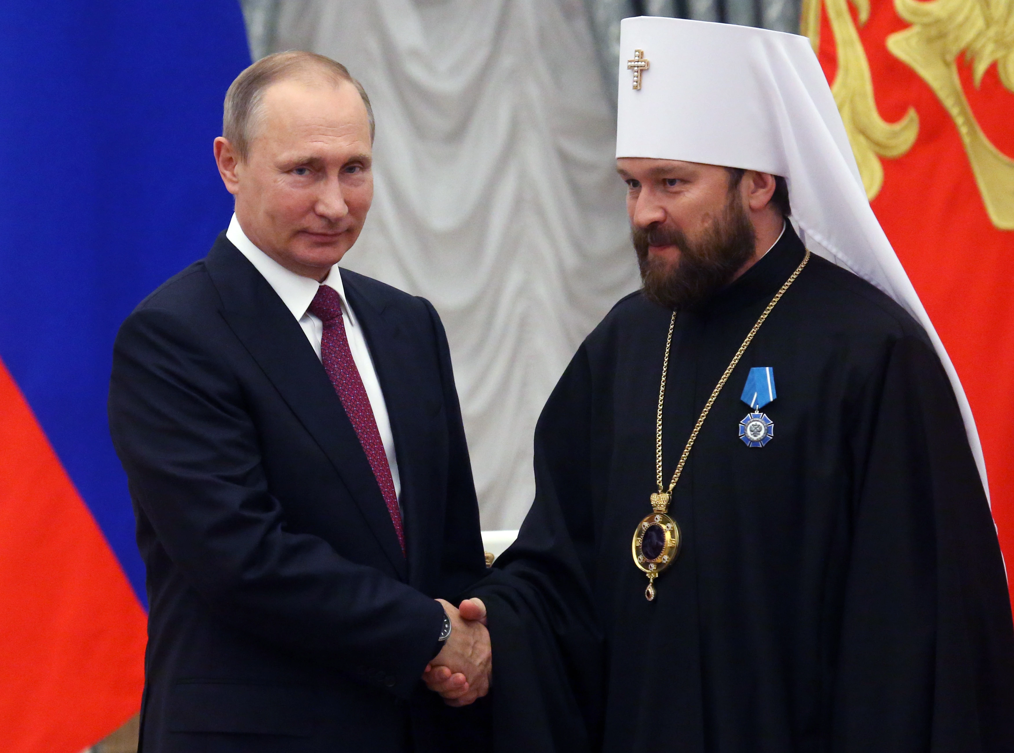 Russian President Vladimir Putin shakes hands with Russian Orthodox Church Bishop Hilarion Alfeyev during a state  ceremony at the Kremlin in Moscow on Sept. 22, 2016.?w=200&h=150