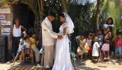 Filipino newlyweds dance in the street during a reception in Baleno town, Masbate island province in the central Philippines, April 15, 2007.