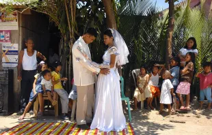 Filipino newlyweds dance in the street during a reception in Baleno town, Masbate island province in the central Philippines, April 15, 2007. Credit: ROMEO GACAD/AFP via Getty Images