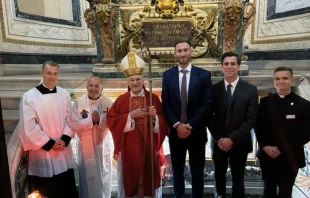 Former NBA All-Star Gordon Hayward (center) at the tomb of St. Sebastian at Rome’s Cathedral of St. Sebastian after entering the Catholic Church this year. He received the sacraments of initiation from Archbishop Timothy Broglio, USCCB president and archbishop of the Archdiocese for the Military Services, USA. Credit: Archdiocese for the Military Services, USA