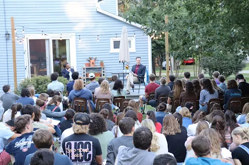 Students gather in the backyard of The Grotto for a talk by two of Hillsdale’s Catholic professors. Credit: Kelly Cole.