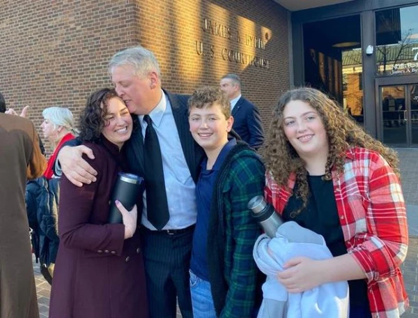 After being acquitted of federal charges by a jury in Philadelphia on Monday, Jan. 30, 2023, Mark Houck embraces and kisses his wife, Ryan-Marie Houck. Also with Houck are his son Mark Houck Jr., 14, and his daughter, Ava Houck, 12. Credit: Joe Bukuras/CNA