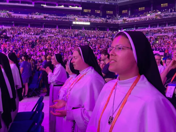 Mother Amata Veritas, OP; Sister Hyacinth, OP; Sister Irenaeus, OP; and Sister Agnes Maria, OP, pray in Lucas Oil Stadium at the 2024 National Eucharistic Congress in Indianapolis. Credit: Photo courtesy of the Dominican Sisters of Mary, Mother of the Eucharist