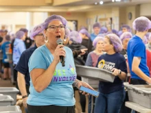 Lori Stillwell, a volunteer and a member of the local Kiwanis Club, directs nearly 600 volunteers who gathered Nov. 2, 2024, at St. Isidore Parish in Macomb, Michigan, to package 100,000 meals in partnership with the Kids Coalition Against Hunger. The massive annual effort brought together volunteers from the Disciples Unleashed Family of Parishes as well as the local community to aid victims of natural disasters, including the recent hurricanes in the U.S. South.