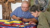 John Kraemer shows off the interior of one of his Lego churches to an interested parishioner at Resurrection of the Lord Parish in Standish, Michigan.