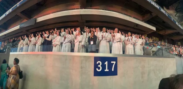 Dominican sisters adore the Lord as he enters Lucas Oil Stadium at the 2024 National Eucharistic Congress in Indianapolis. Credit: Photo courtesy of the Dominican Sisters of Mary, Mother of the Eucharist