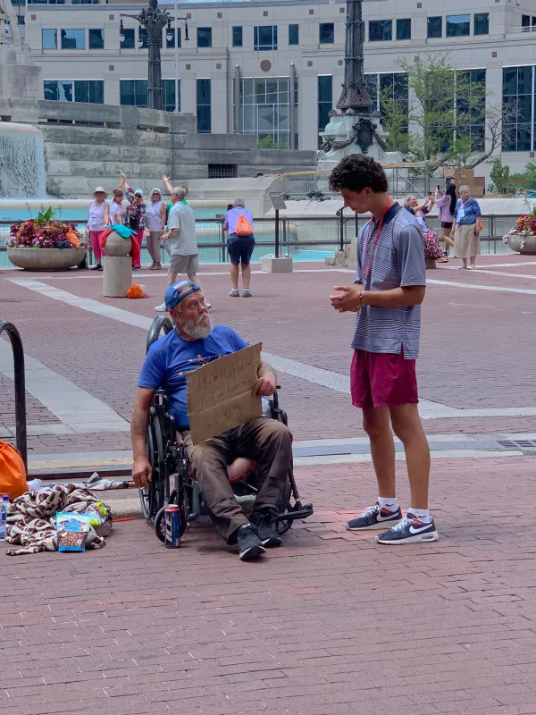 A participant chatting with a homeless man during the 2024 National Eucharistic Congress in Indianapolis. Credit: Jonah McKeown/CNA