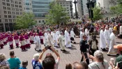 Bishops and priests process past the Soldiers and Sailors Monument in downtown Indianapolis.