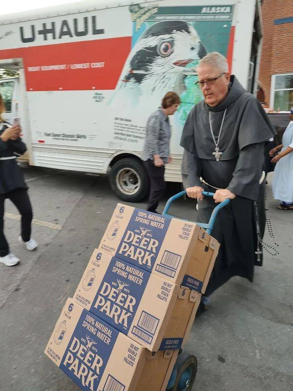 Bishop Michael Martin helps move supplies at Immaculata Catholic School in Hendersonville, North Carolina, Friday, Oct. 4, 2024. Credit: Diocese of Charlotte