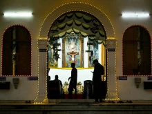 People visit the St. Patrick Catholic Church, illuminated with decorative lights on Christmas Eve in Chennai, Tamil Nadu, India, on Dec. 24, 2024.