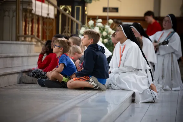 Children spend time before the Blessed Sacrament during a special time of "family adoration" at St. John the Evangelist Church. Credit: Jeffrey Bruno