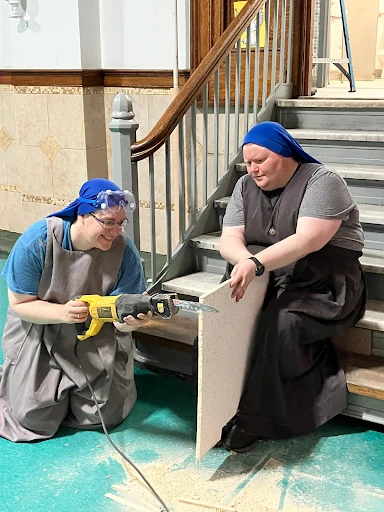 Sister Mary Mother of Truth Westermeyer, a Servidora and principal of Saint John Paul the Great Academy (right), works with another Servidora to prepare the school. Credit: Saint John Paul the Great Academy.