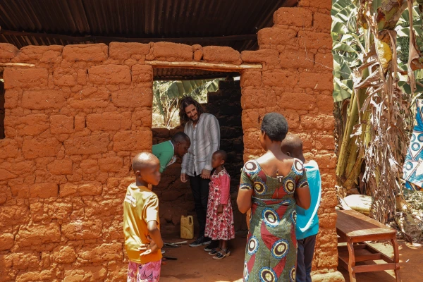 Catholic actor Jonathan Roumie visits Emelyne and her family in Rwanda. Credit: Unbound