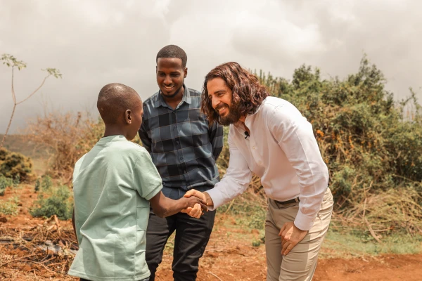 Catholic actor Jonathan Roumie meets Ibrahimu, whom he has been sponsoring through Unbound since 2019, in Tanzania. Credit: Unbound