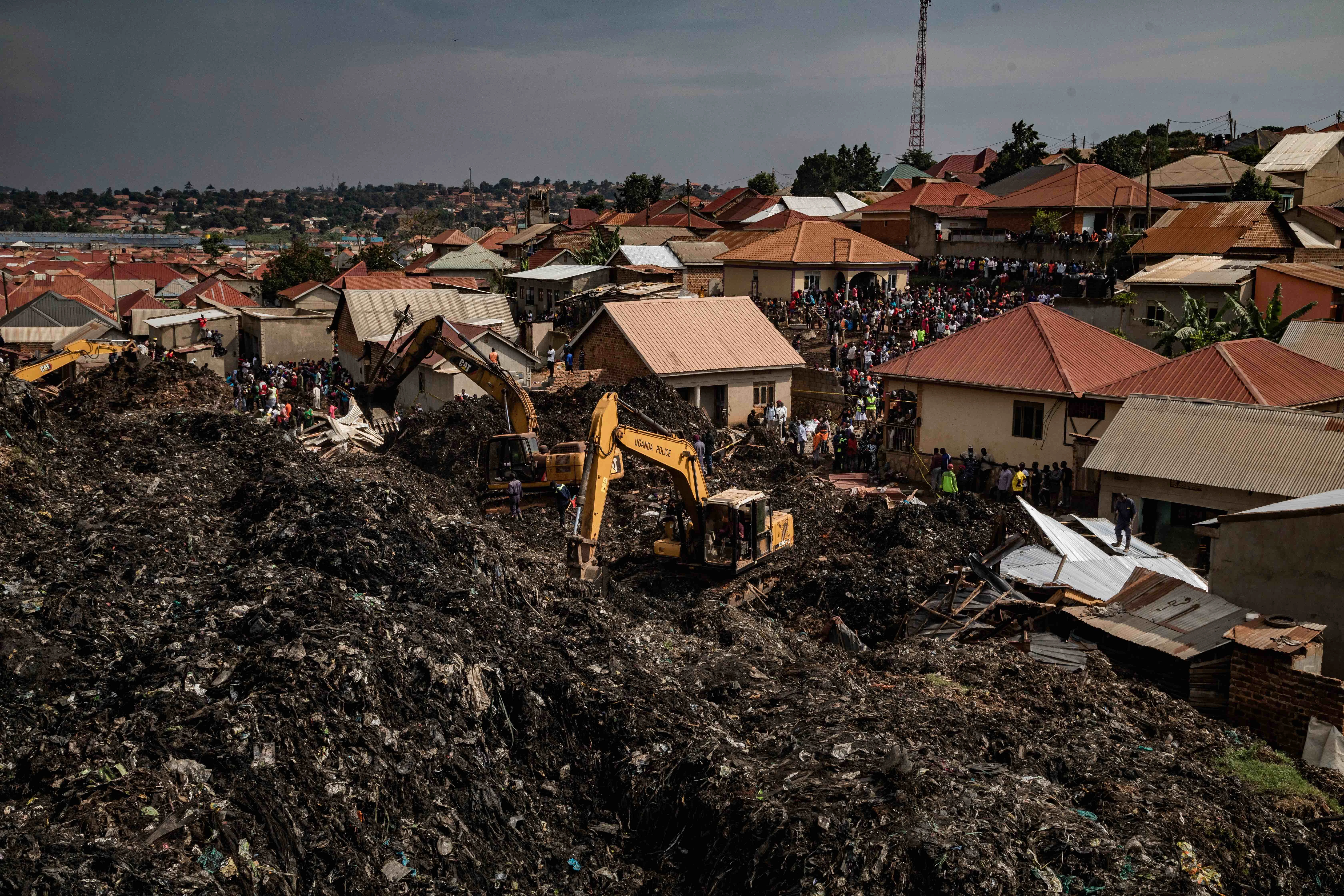 People look on as an excavator helps search for people trapped under debris after a landfill collapsed in Kampala, Uganda, on Aug. 10, 2024. Eight people including two children were killed when mountains of garbage collapsed at a landfill, the city authority said.?w=200&h=150